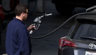 (FILES) This file photo taken on May 09, 2017 shows a customer preparing to pump gasoline into his car at a gas station in San Anselmo, California.  AFP  / JUSTIN SULLIVAN