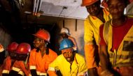 City Power contractors working underground in Johannesburg, South Africa pull through new power cabling as it is fed to them from an above ground site on September 8, 2017. AFP / Tadeu Andre