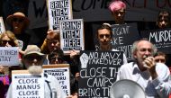 Refugee advocates protest against the closing of asylum-seeker camps in Papua New Guinea, in front of the Sydney Commonwealth government offices on October 31, 2017, as they demand the resettlement of the refugees to Australia. AFP / SAEED KHAN