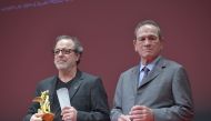 TOKYO, JAPAN: Turkish movie Director Semih Kaplanoglu (L) receives the Tokyo Grand Prix and The Governor of Tokyo Award from the President of Jury Tommy Lee Jones (R) for the movie 'GRAIN' during the closing ceremony of the 30th Tokyo International Film F
