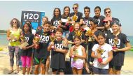 ‘The podium winners at the Swim for a Cause’ open water swimming races organised by Sharq Village and Spa at the Sharq Village & Spa Beach pose for  a group picture.