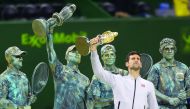 Serbian Novak Djokovic poses with the 2017 ExxonMobil Qatar Open trophy at the Khalifa International Tennis Complex in Doha in this file photo