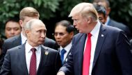 U.S. President Donald Trump and Russia's President Vladimir Putin talk during the family photo session at the APEC Summit in Danang, Vietnam November 11, 2017. REUTERS/Jorge Silva.