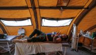An Iranian quake victim lies on an operating bed after receiving treatment at a field hospital in the town of Sarpol-e Zahab in the western Kermanshah province near the border with Iraq, on November 14, 2017, following a 7.3-magnitude earthquake that left
