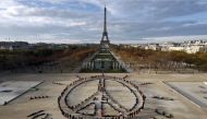 A Reuters file photo of environmentalists forming a message of hope and peace in front of the Eiffel Tower in Paris, France.