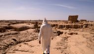 This file photo taken on October 27, 2016 shows a man walking through a dried out area, that used to be part of the Tafilalet oasis, near Morocco's southeastern oasis town of Erfoud, north of Er-Rissani in the Sahara Desert.  AFP / Fadel Senna  

