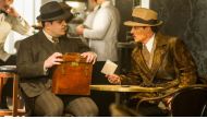 A still of actors Johnny Depp and Josh Gad (R) from the movie Murder on the Orient Express.