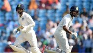 Indian cricketers Murali Vijay (L) and Cheteshwar Pujara run between the wickets during the second day of the second Test cricket match between India and Sri Lanka at the Vidarbha Cricket Association Stadium in Nagpur on November 25, 2017.  AFP / PUNIT PA