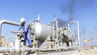 A worker checks the valve of an oil pipe at Nahr Bin Umar oil field, north of Basra, Iraq December 21, 2015. REUTERS/Essam Al-Sudani