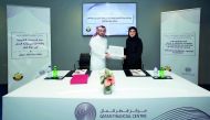 Nasser Al Taweel (left), Chief Legal Officer at the QFC Authority; and Fatma Abdulaziz Bilal, Director of the Legal and Judicial Studies Centre at the MOJ during the MoU signing