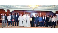 Dr Abdulbasit Ahmad Al Shaibei (centre), QIIB CEO; and the bank’s top officials, with students and staff members of Voltaire School, during their visit to the bank. 