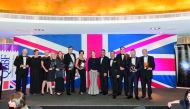 Ajay Sharma (fourth right), British Ambassador to Qatar, and other dignitaries and company officials, posing for a group photo with the winners of the 3rd QBBF annual awards at the event. 