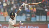 Indian batsman and team captain Virat Kohli (R) plays a shot during the second day of the third Test cricket match between India and Sri Lanka at the Feroz Shah Kotla Cricket Stadium in New Delhi on December 3, 2017. GETTYOUT / AFP / SAJJAD HUSSAIN 