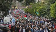 Palestinian and Lebanese protesters take to the streets in the Lebanese capital Beirut on December 8, 2017 to denounce the widely criticised decision by US President Trump to recognise Jerusalem as the capital of Israel. / AFP / ANWAR AMRO.