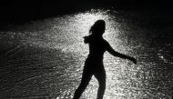 A woman skates in the sun over wet ice following heavy rain showers at the Tower of London ice rink in London, Britain, December 29, 2017. REUTERS/Toby Melville
