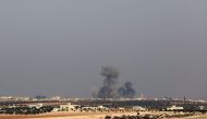 A picture taken on December 29, 2017, from a village in southern Idlib, shows smoke billowing following reported airstrikes on the village of Um Jalal in Syria's northwestern Idlib province.   AFP / OMAR HAJ KADOUR
