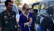 Australian national Tammy Davis-Charles (C) is escorted by Cambodian prison guard to the Court of Appeal in Phnom Penh on January 8, 2018. / AFP / TANG CHHIN SOTHY