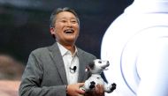 Kazuo Hirai, president and CEO of Sony Corporation, holds an Aibo robotic dog during a news conference at the 2018 CES in Las Vegas, Nevada, U.S. January 8, 2018. REUTERS/Steve Marcus 
