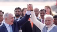 Israeli Prime Minister Benjamin Netanyahu and his Indian counterpart Narendra Modi raise their arms upon Netanyahu’s arrival at Air Force Station Palam in New Delhi, India, January 14, 2018. REUTERS/Adnan Abidi
