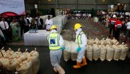 Police officers carry a haul of seized cocaine sack to be destroyed under judicial supervision in Katunayake, Sri Lanka January 15, 2018. Reuters/Dinuka Liyanawatte
