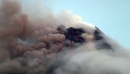 Clouds partially cover Mayon volcano's crater as it spews a column of ash during another mild eruption in Legazpi City, Albay province, south of Manila, Philippines January 16, 2018. REUTERS/Stringer