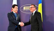 Romanian vice Prime Minister Paul Stanescu (R) welcomes Kotaru Nogami (L), Deputy chief Cabinet Secretary, leader of Japan's official economic delegation, at The Victoria Palace, the headquarters of the Romanian Government on January 16, 2018 in Bucharest