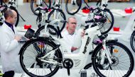 Pierre Forte (R), founder and CEO of Pragma Industries, and Alexandre Blanc (L), operations director, check an Alpha bike, first industrialised bicycle to use a hydrogen fuel cell at the Pragma Industries factory in Biarritz, France, January 15, 2018. Pic