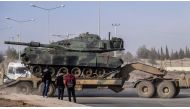 A photo made available by the Dogan New Agency shows Turkish army military trucks transporting armoured vehicles to reinforce the border units in Sanliurfa close to the Syrian border on January 16, 2018. AFP / DHA
