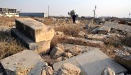 An Iraqi man walks amid the remains of headstones of British soldiers who were killed during the first and second world wars, at the Mosul War Cemetery in Mosul city, northern Iraq, 17 January 2018. EPA/AMAR SALIH
