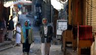 Yemenis walk through a market in the old city of Sana'a, Yemen, 19 January 2018. EPA/YAHYA ARHAB
