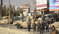 Afghan security personnel keep watch at the entrance of the Intercontinental Hotel during a fight between gunmen and Afghan security forces in Kabul on January 21, 2018. AFP / SHAH MARAI
