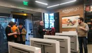Shoppers enter the Amazon Go store located in Amazon's 