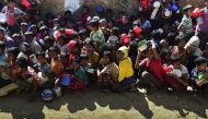 This picture taken on January 21, 2018, shows Rohingya refugees waiting for food aid at Thankhali refugee camp in Bangladesh's Ukhia district. / AFP / MUNIR UZ ZAMAN