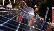 FILE PHOTO: Solar installers from Baker Electric place solar panels on the roof of a residential home in Scripps Ranch, San Diego, California, U.S. October 14, 2016. REUTERS/Mike Blake/File Photo 