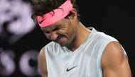 Spain's Rafael Nadal grimaces as he walks on court while preparing to serve to Croatia's Marin Cilic during their men's singles quarter-finals match on day nine of the Australian Open tennis tournament in Melbourne on January 23, 2018. World No.1 Rafael N