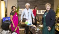 IMF Director Christine Lagarde (C) reacts after kicking a football with the UN sustainability goals given her by the Norwegian Prime Minister Erna Solberg (R), during their meeting at the World Economic Forum (WEF) annual meeting in Davos, Switzerland, 23