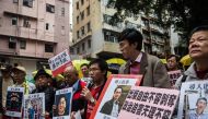 (FILES) This file picture taken on January 3, 2016 shows protesters holding up missing person notices of (L-R) Mighty Current publisher of books critical of China company's general manager Lui Bo and colleagues Cheung Jiping, Gui Minhai, Lee Bo and Lam Wi