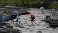 Filipino villagers traverse a river following a flash flood at the slope of the rumbling Mayon Volcano in the town of Daraga, Albay province, Philippines, 27 January 2018. EPA/FRANCIS R. MALASIG
