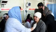 Afghan medical staff treat a wounded women, after a car bomb exploded near the old Interior Ministry building, at Jamhuriat Hospital in Kabul on January 27, 2018. (AFP / WAKIL KOHSAR)