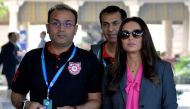 ollywood actor and owner of Kings XI Punjab Team, Preity Zinta (R) and team mentor, Virendra Sehwag arrive for the 2nd day of IPL 2018 Player Auction in Bangalore on January 28, 2018. / AFP / MANJUNATH KIRAN
