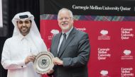 Michael Trick, dean of CMU-Q  presents a memento to  Abdulaziz Bin Nasser Al-Khalifa  