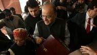 Indian Finance Minister Arun Jaitley (C) arrives at Parliament House to present the Union Budget in New Delhi on February 1, 2018. AFP / Money SHARMA
