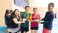 Mixed Doubles winner Raquel Bamba and Ryan Bamba, receiving the winner's trophy from Carmencita Ortiaga (left), President of Flickers Qatar and Renato Ajero (right), Founder of Flickers Qatar.