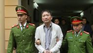 File photo of PVC's former chairman Trinh Xuan Thanh is escorted by police officers from a court to prison after verdict session in Hanoi, Vietnam January 22, 2018. VNA/Doan Tan via REUTERS