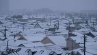 File photo of roofs of houses covered with snow in Tokyo on February 2, 2018. / AFP / Kazuhiro NOGI
