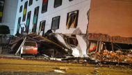 A damaged vehicle stands in rubble outside the Marshal Hotel in Hualien, eastern Taiwan early February 7, 2018, after a strong earthquake struck the island. AFP / Paul Yang
