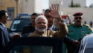 Indian Prime Minister Narendra Modi waves upon his arrival for a meeting with Palestinian president Mahmud Abbas in the West Bank city of Ramallah on February 10, 2018. / AFP / ABBAS MOMANI
