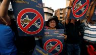 Pro-democracy activists hold up placards during protest against junta near Democracy Monument in Bangkok, Thailand, February 10, 2018. Reuters/Soe Zeya Tun	