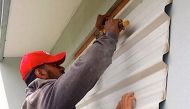 A supplied image shows locals covering windows to office buildings as part of preparations for Cyclone Gita in the tonga capital of Nuku'alofa, February 12, 2018. Taniela Hoponoa/CARE Australia/Handout via REUTERS 