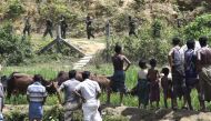 Rohingya Muslim refugees in Jalpatoli refugee camp, in the no-man's land area between Myanmar and Bangladesh, watch as Myanmar soldiers patrol on the other side of the border, near Gumdhum village in Ukhia. AFP / DOMINIQUE FAGET / XGTY